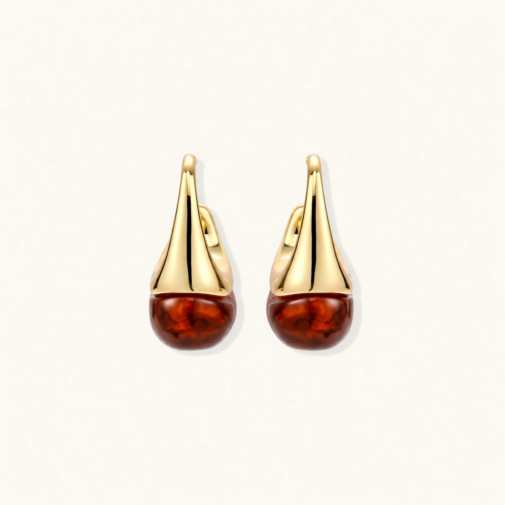 Modern drop earrings with curved gold-plated copper tops and amber resin bottoms creating an organic teardrop silhouette.