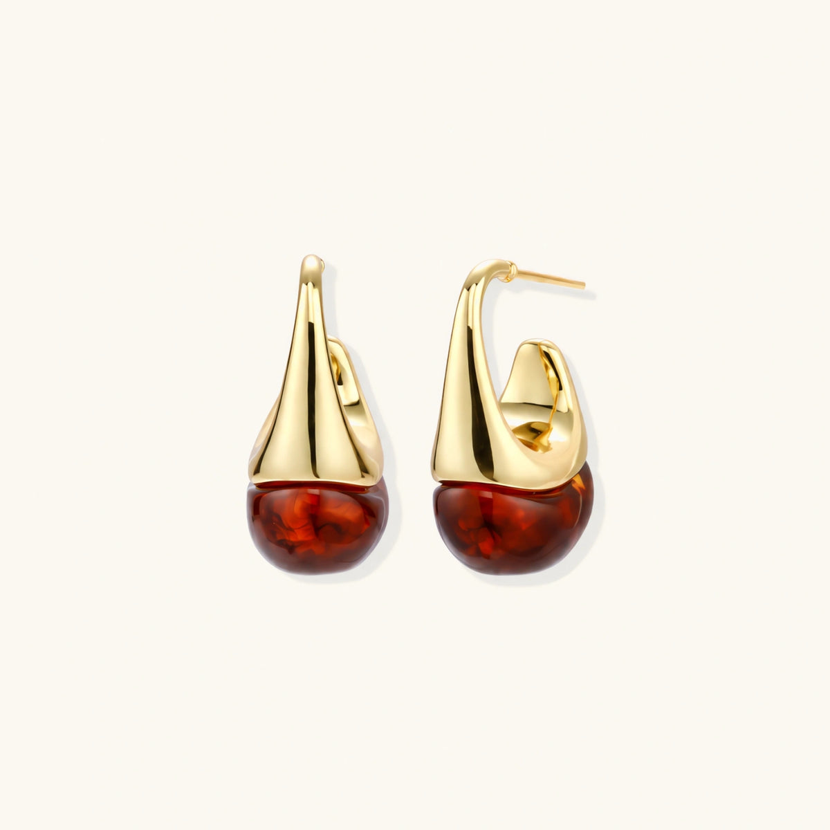 Modern drop earrings with curved gold-plated copper tops and amber resin bottoms creating an organic teardrop silhouette.