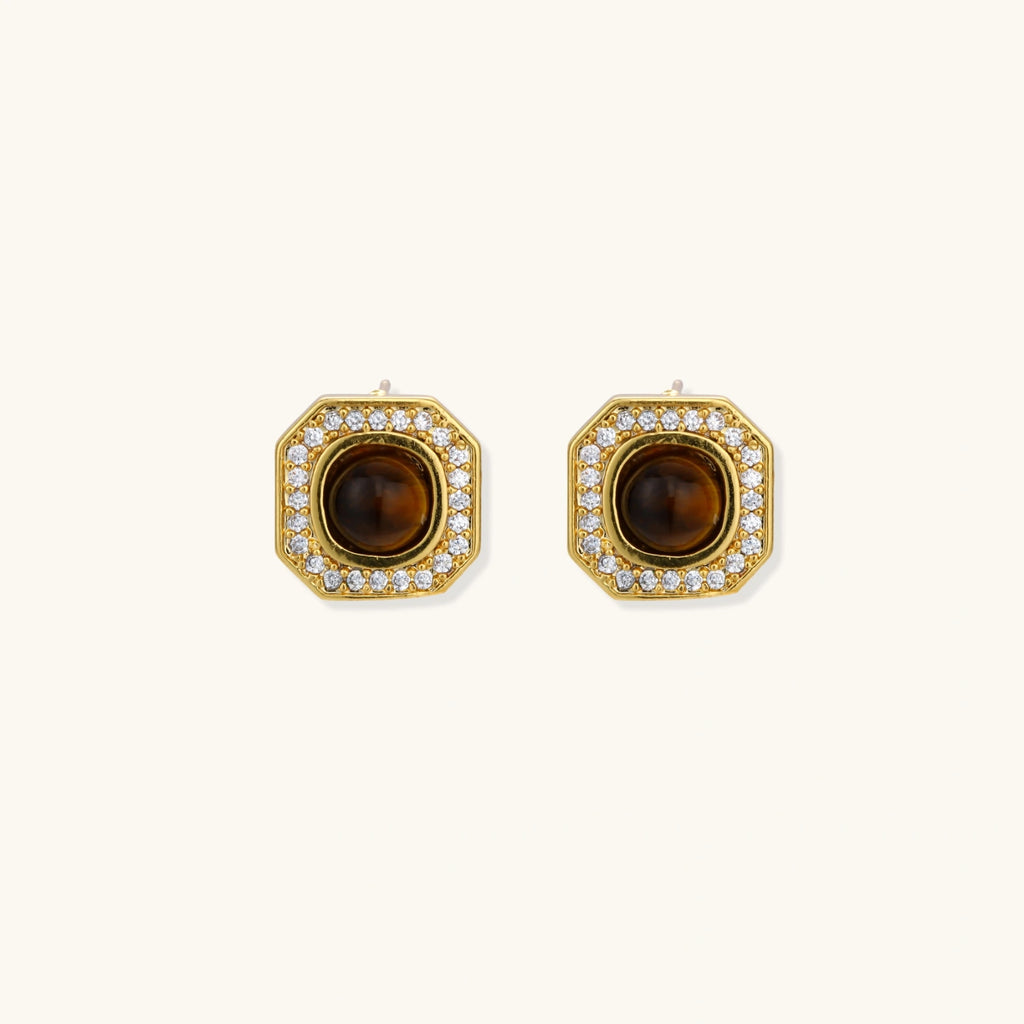 Gold-plated octagonal stud earrings with brown tiger's eye centers and cubic zirconia border on cream background.
