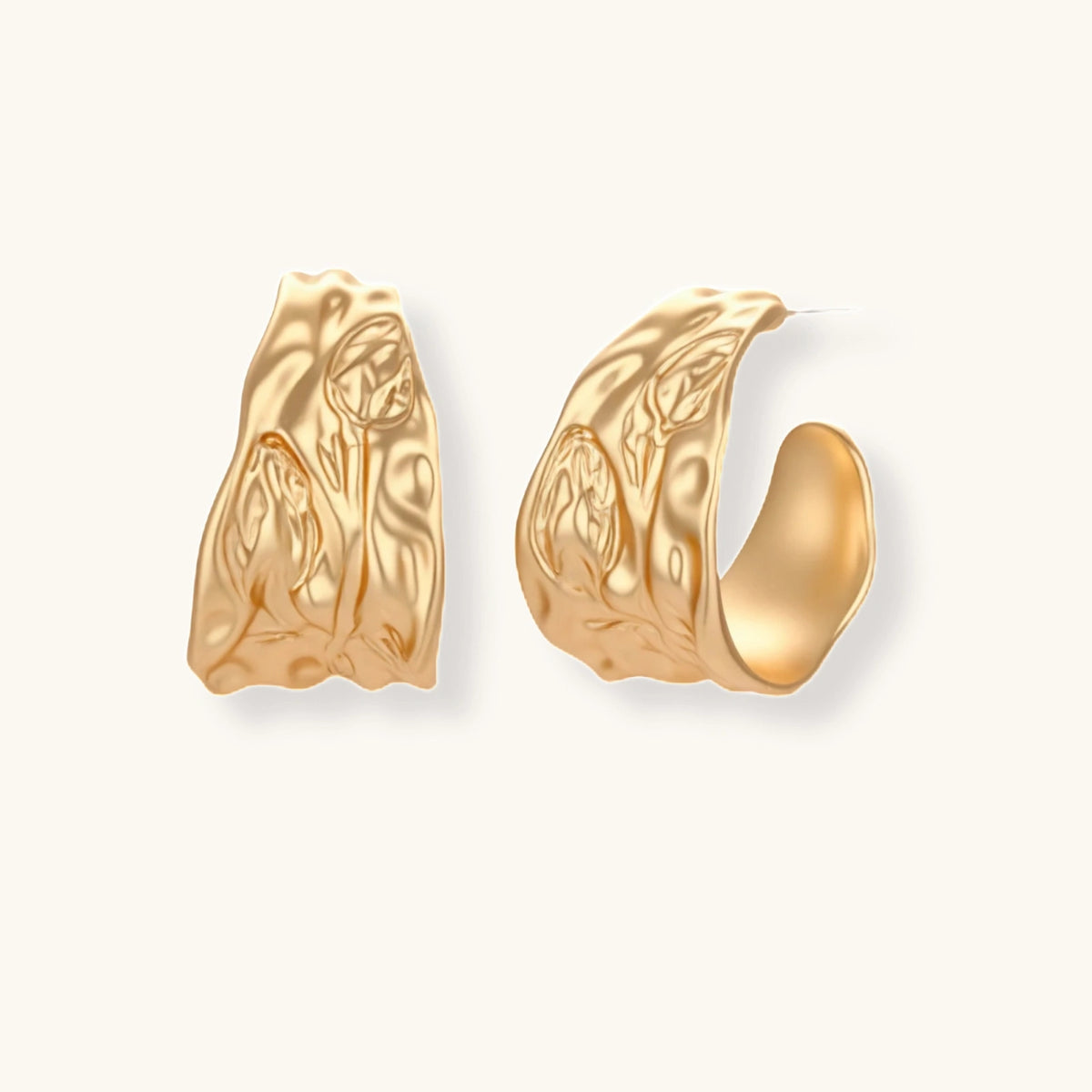Gold-toned hoop earrings with organic ripple texture and molten-like surface design on neutral background.