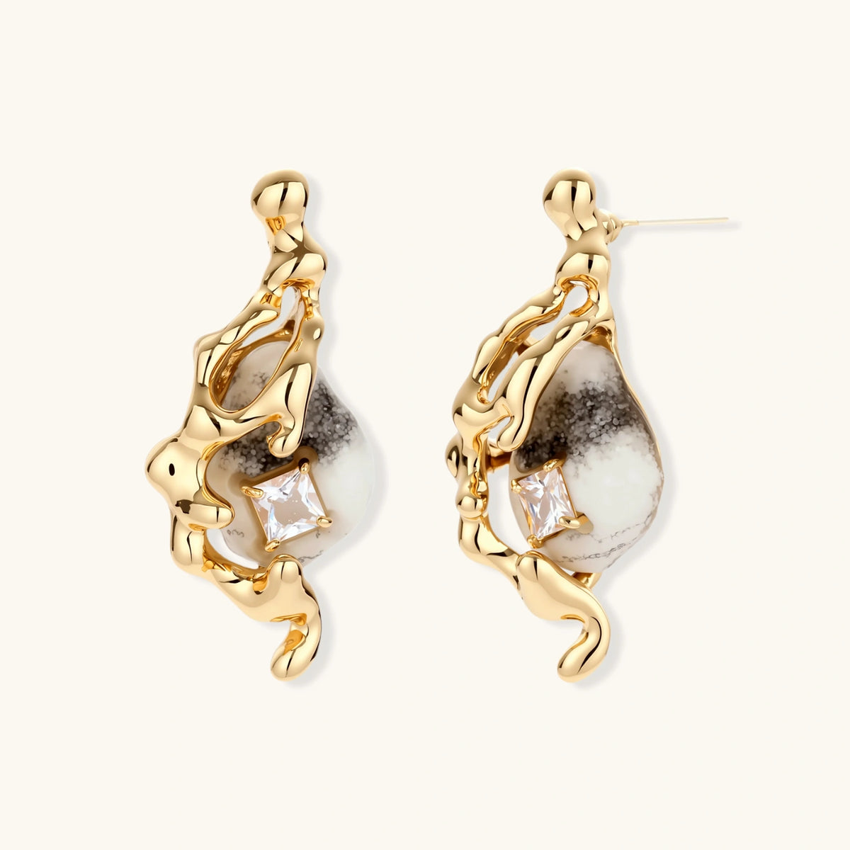 Gold-toned dangle earrings with marbled resin stones and flowing serpentine chain design on neutral background