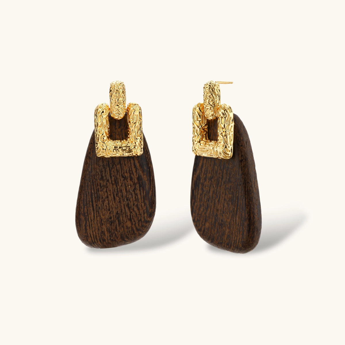Elegant drop earrings featuring intricate 18k gold plated copper metalwork with dark brown wooden teardrop pendants